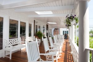 A photo of the front porch of a hotel near Edgartown, MA restaurants. 