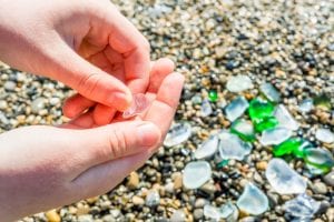 A photo of someone searching for sea glass at one of the best beaches in Martha's Vineyard.