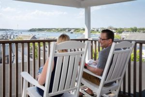 A couple sitting on the patio at one of the best Martha's Vineyard boutique hotels during their honeymoon.