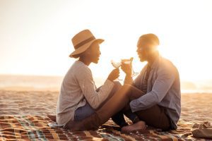 A couple relaxing on the beach while enjoying their honeymoon at one of the best boutique hotels in Martha's Vineyard.