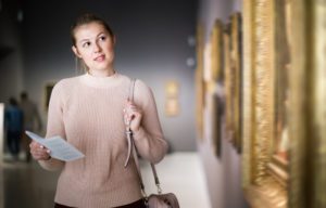 A woman walking around a museum while visiting Martha's Vineyard in winter.