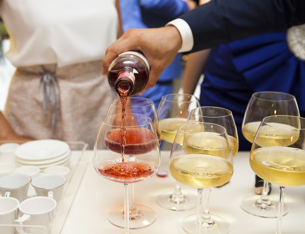 Man pouring wine into a glass.