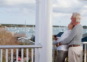 A couple relaxing on the porch of an Edgartown hotel after successfully figuring out how to get to Martha's Vineyard.