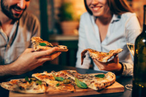 A group of people eating pizza at a Martha's Vineyard spot.