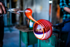 A person working on a glass piece at a workshop in West Tisbury.