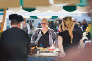 A woman at a booth at the Martha's Vineyard Food and Wine Festival.