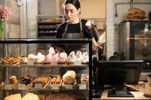 A person stocking the bakery case at one of the best places to eat on Martha's Vineyard for something sweet.